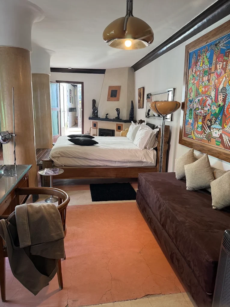 A suite at Riad Malika, with its fireplace and works of art, Marrakech medina