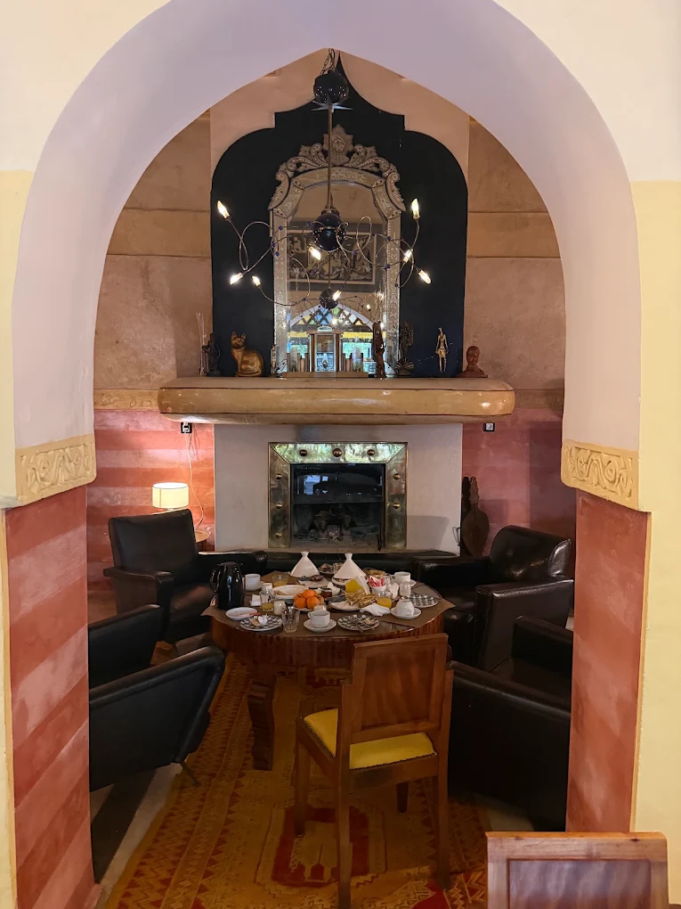 A table set in front of the living-room fireplace at Riad Malika, Marrakech medina